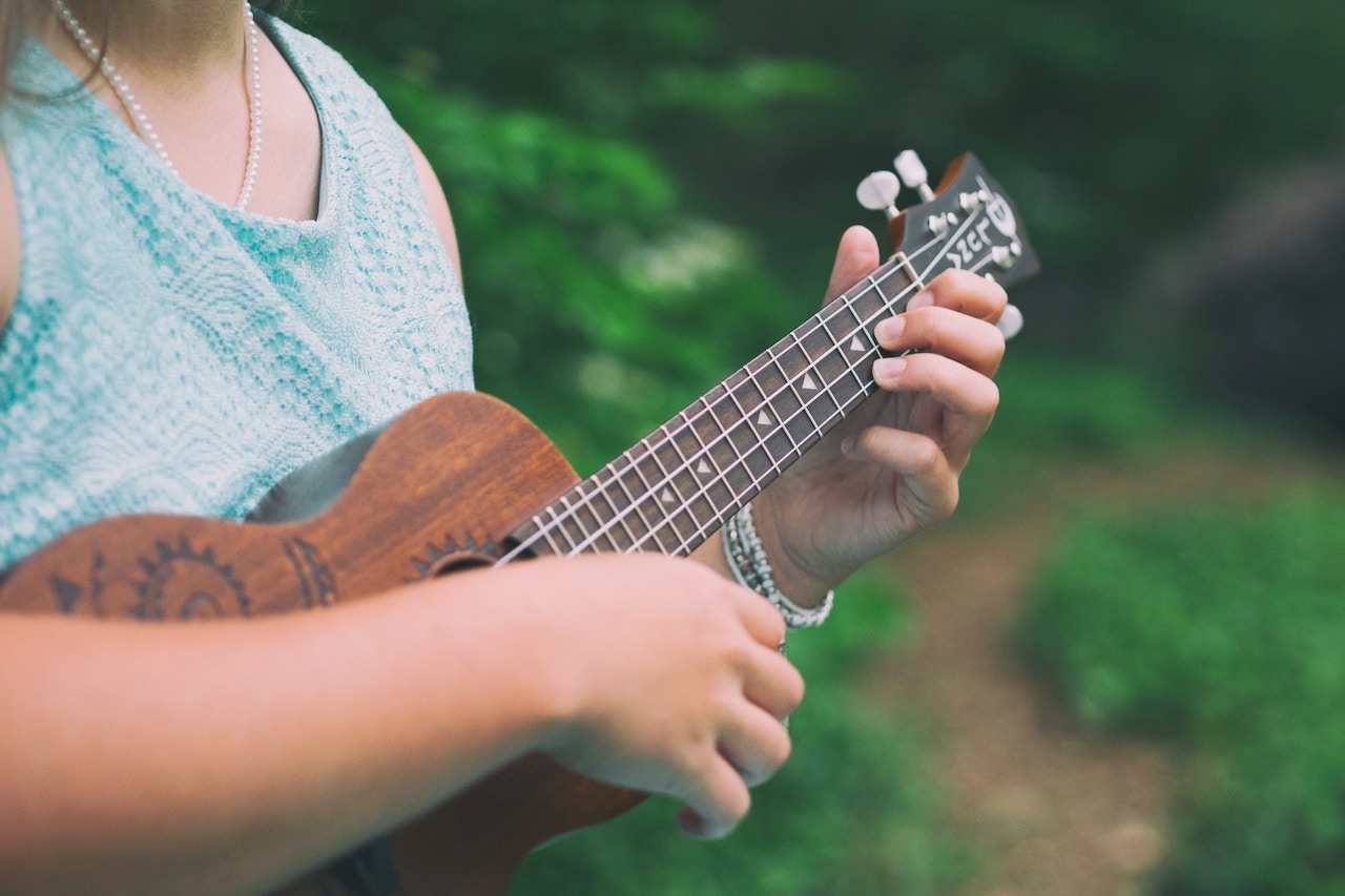 A woman playing ukulele